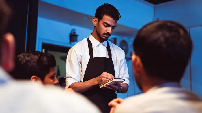 Camarero tomando una comanda con una tableta en un restaurante